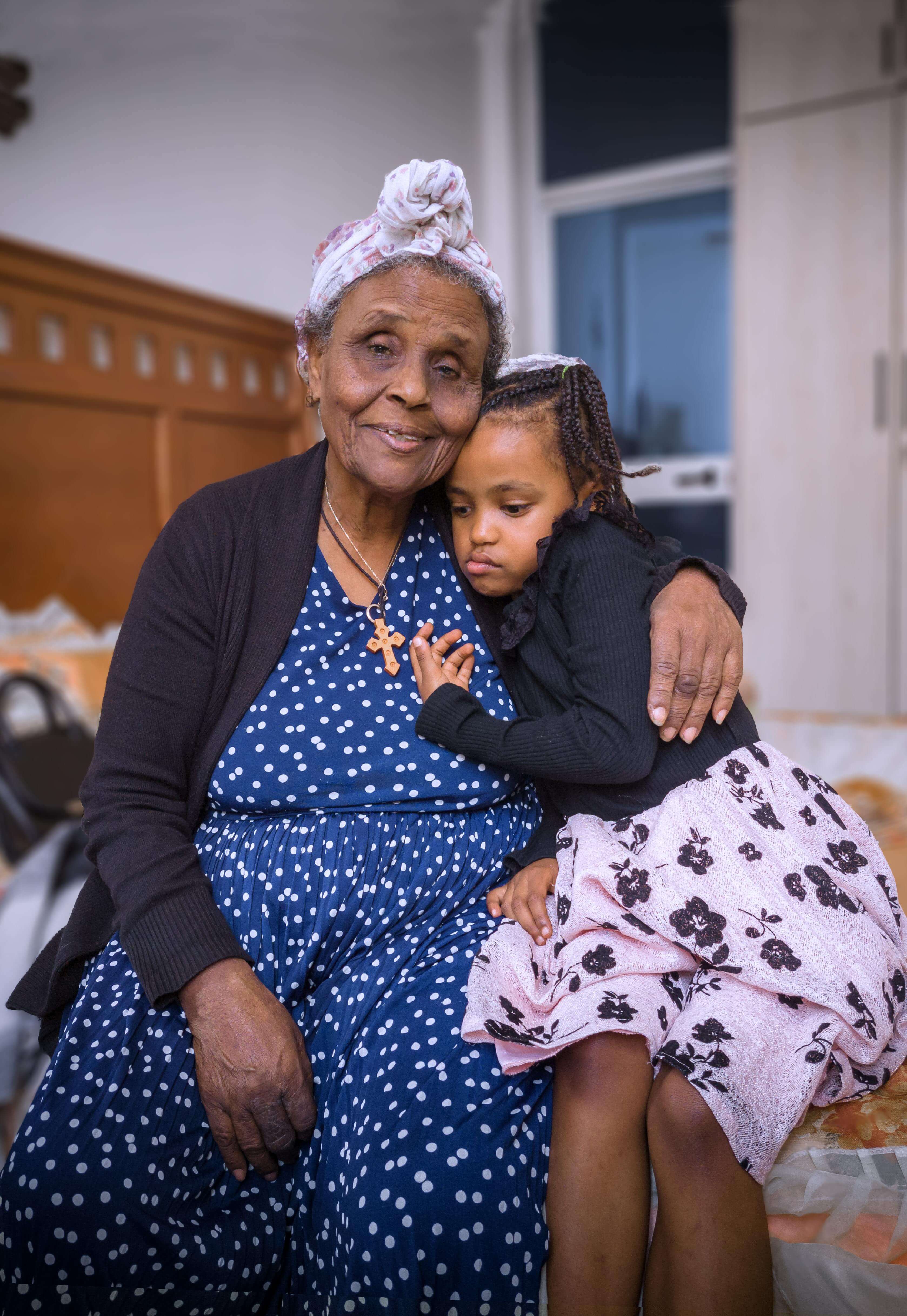 Grandmother and granddaughter sitting together